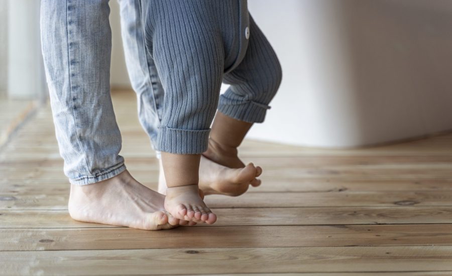 baby-learning-how-to-walk-and-being-helped-by-his-mother