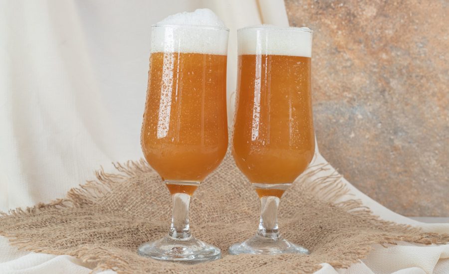 Two glasses of foamy beer on burlap. High quality photo